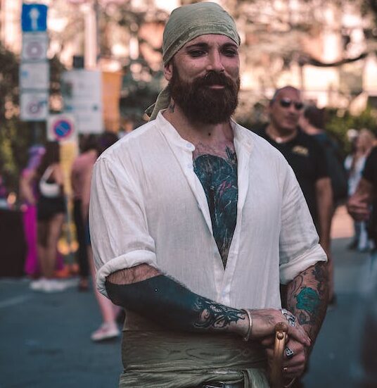 free photo of portrait of a tattooed man wearing a pirate costume e1702471911500 - Rosario Nautico